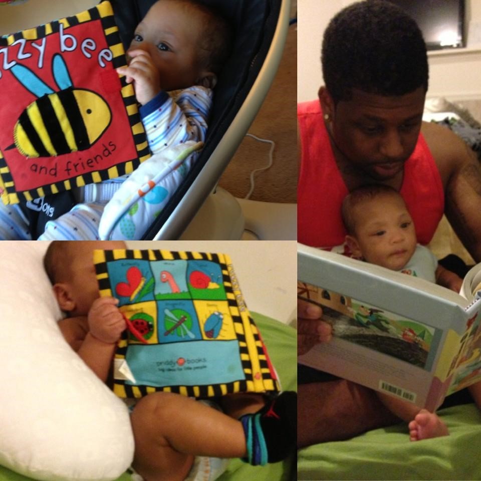 baby reading with dad